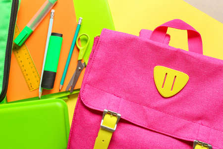 School backpack with stationery on color backgroundの写真素材