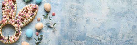Beautiful cake for Easter celebration on blue background with space for text