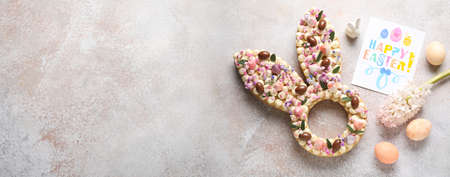 Beautiful cake and greeting card for Easter celebration on grunge background with space for textの写真素材