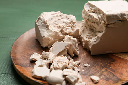 Plate with fresh yeast on wooden backgroundの写真素材