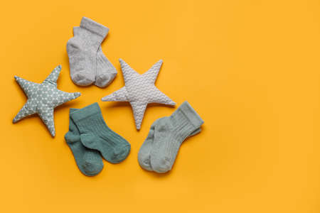 Baby socks and toys on color backgroundの写真素材