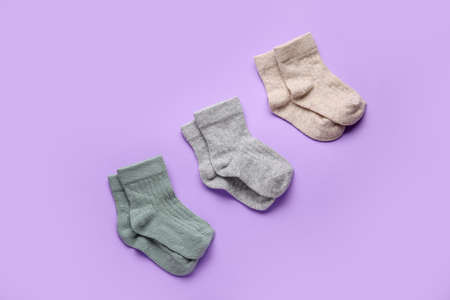 Different baby socks on color backgroundの写真素材