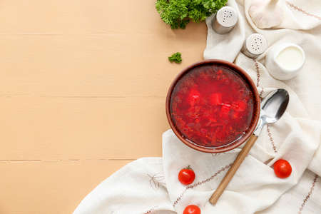 Bowl with tasty borscht on color wooden backgroundの写真素材