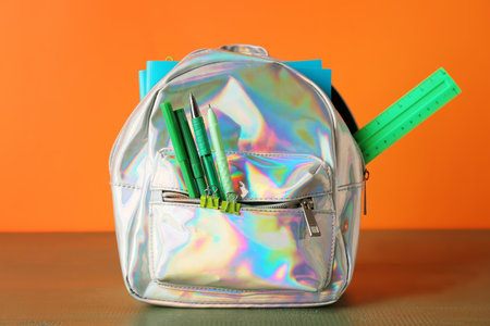 School backpack and stationery on color backgroundの写真素材