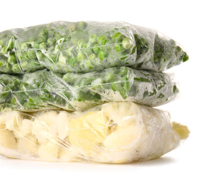 Plastic bags with frozen vegetables on white backgroundの写真素材