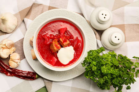 Composition with tasty borscht on fabric background