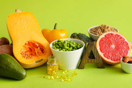 Set of healthy products with pills on color background
