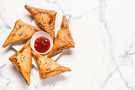 Tasty Uzbek samsa and tomato sauce on white backgroundの写真素材