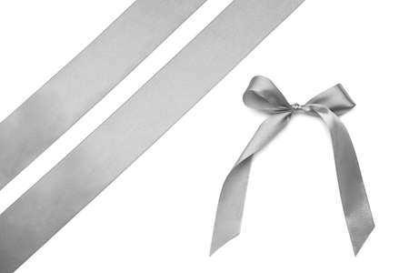 Beautiful silver bow with ribbons on white backgroundの写真素材