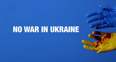Human hands in colors of Ukrainian flag and with blood stains on blue background. No war in Ukraine
