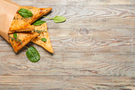 Tasty Uzbek samsa on wooden background