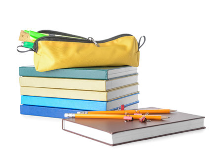 Stack of books and pencil case with stationery on white backgroundの写真素材