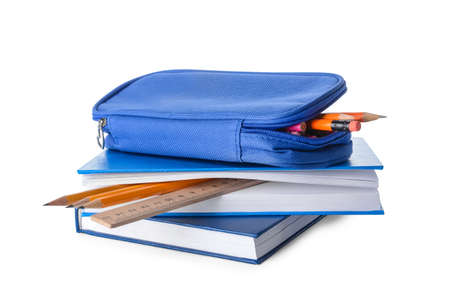 Books and pencil case with stationery on white background