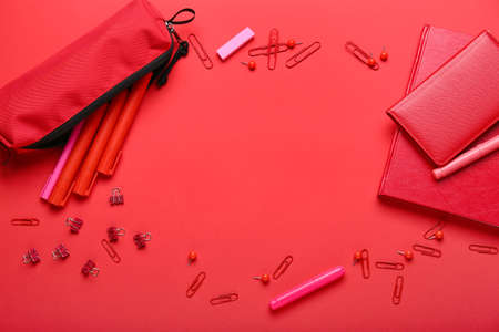 Frame made of stationery on red backgroundの写真素材