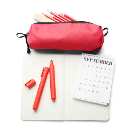 Composition with notebook, calendar, markers and pencil case on white backgroundの写真素材
