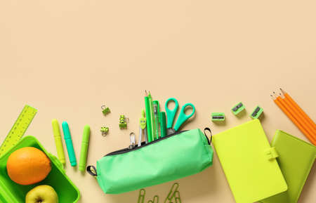 Set of colorful stationery and fruits on color backgroundの写真素材