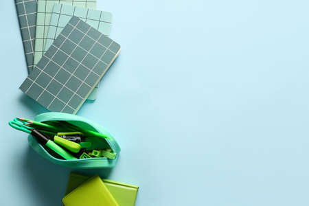 Set of stationery with pencil case and notebooks on color backgroundの写真素材