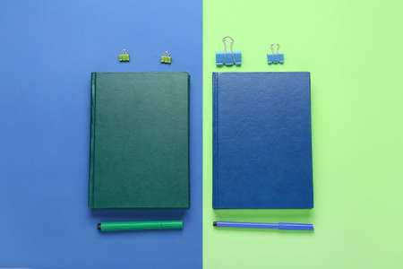 Notebooks, paper clips and markers on color backgroundの写真素材