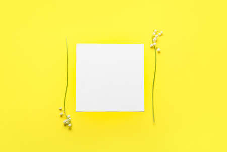 Blank card and beautiful lily-of-the-valley flowers on color backgroundの写真素材