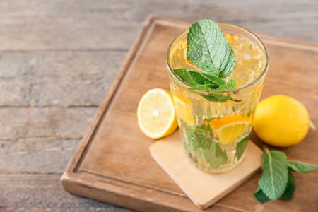 Glass of tasty ice tea with lemon on wooden backgroundの写真素材