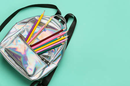 Stylish backpack and pencils on color backgroundの写真素材