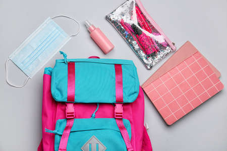School backpack, stationery, sanitizer and medical mask on white backgroundの写真素材
