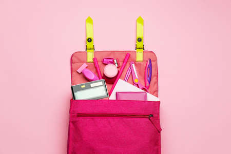 Stylish backpack with different stationery on pink backgroundの写真素材
