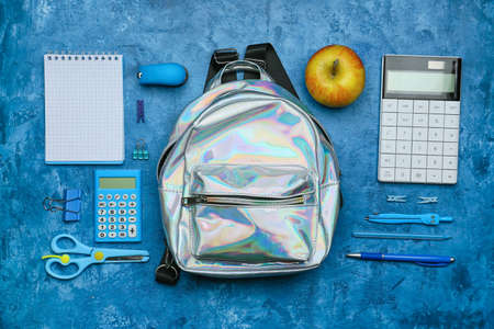 School backpack and stationery on color backgroundの写真素材
