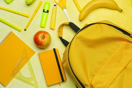 School backpack and stationery on color backgroundの写真素材