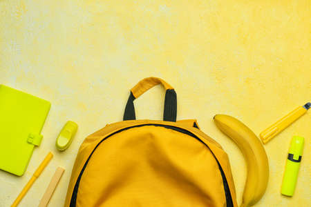 School backpack and stationery on color backgroundの写真素材