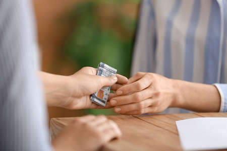 businesswoman taking bribe in officeの写真素材