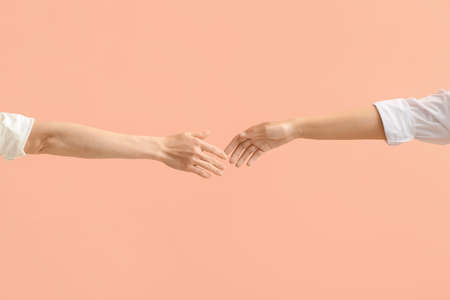 Hands of women on color background