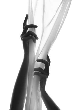 Silhouette of female hands with fabric on white backgroundの写真素材