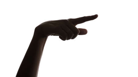 Silhouette of female hand showing something on white backgroundの写真素材