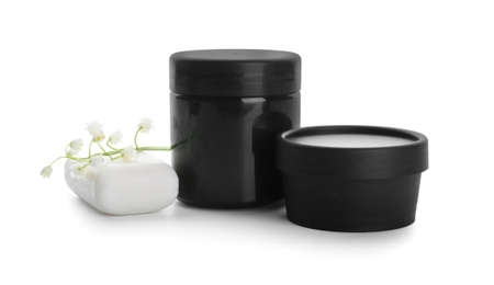 Jars of cream and lily-of-the-valley flowers on white backgroundの写真素材