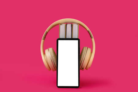 Modern mobile phone, books and headphones on color backgroundの写真素材