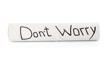 Empty toilet paper cardboard tube with text DON'T WORRY on white backgroundの写真素材