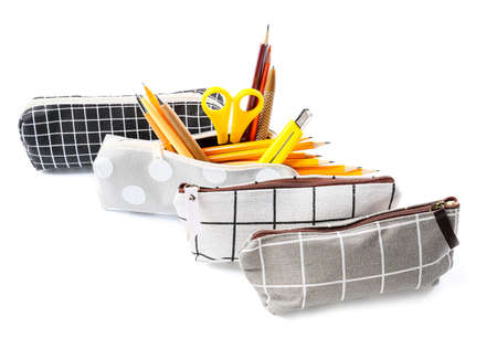 Pencil cases with stationery on white background