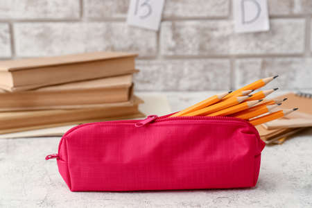 Pencil case with stationery on light table