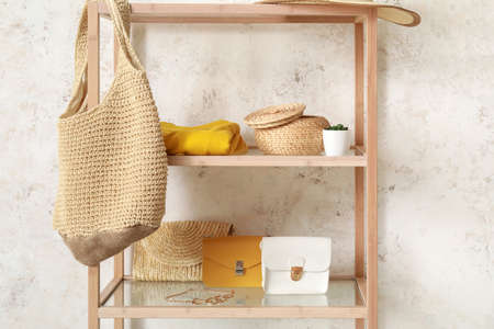 Shelving unit with accessories near light wall