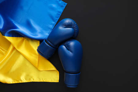 Boxing gloves and flag of Ukraine on black backgroundの写真素材