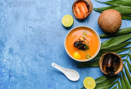 Bowl of spicy Thai soup on color backgroundの写真素材