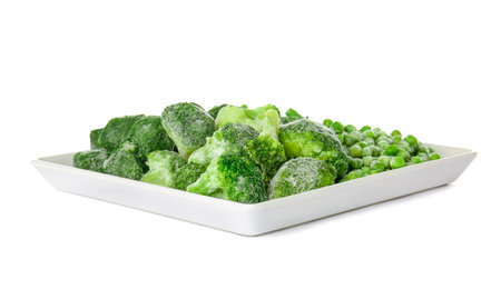 Plate with frozen green vegetables on white backgroundの写真素材