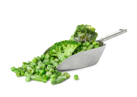Scoop with frozen green vegetables on white backgroundの写真素材