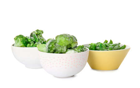 Bowls with frozen green vegetables on white backgroundの写真素材
