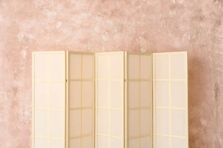 Light folding screen near pink wallの写真素材
