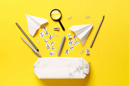 Pencil case and stationery on color backgroundの写真素材