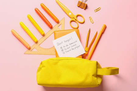 Pencil case and stationery on color background