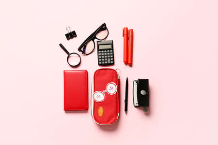 Pencil case and stationery on color background