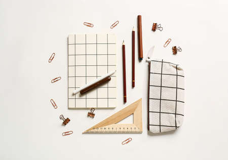 Pencil case and stationery on white background